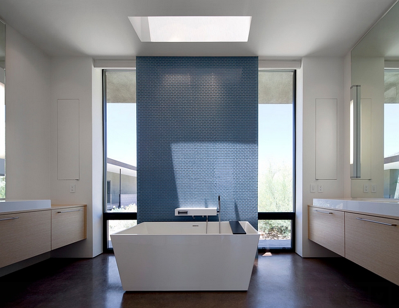 Skylight sheds the spotlight on the accent wall in the minimalist bathroom [Design: Ibarra Rosano Design Architects]