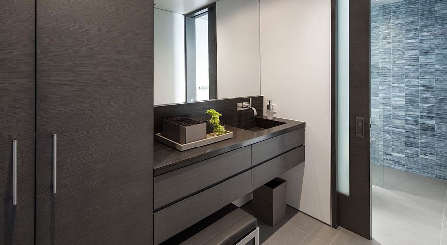 Sliding glass doors connect the bathroom with the bedroom