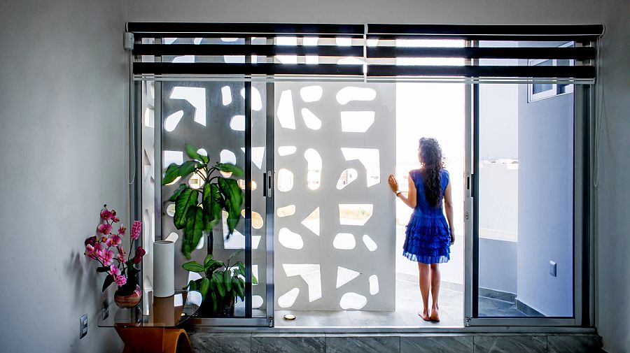 Sliding glass doors connect the interior with the terrace