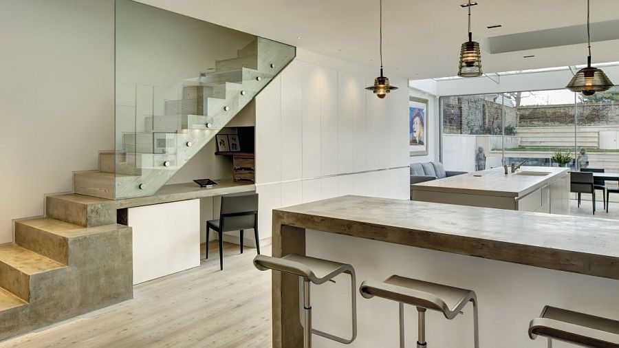 Small workspace under the stairs with ample shelf space next to it