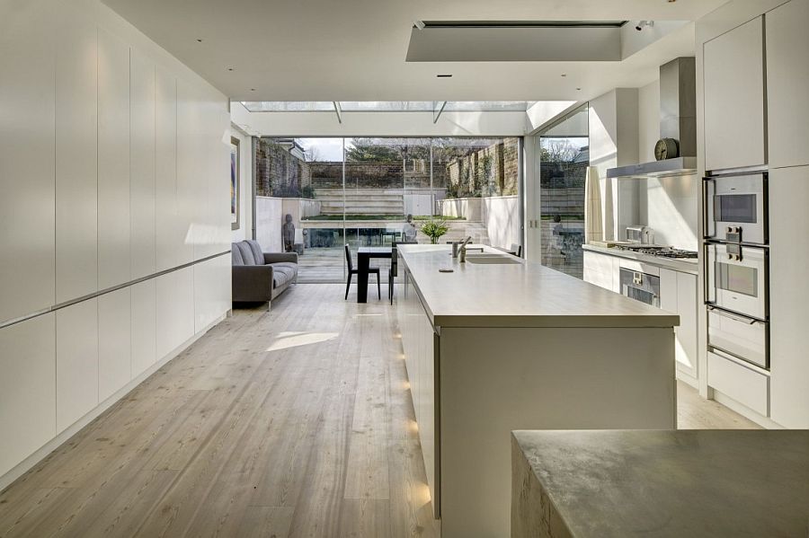 Trendy contemporary kitchen in white adds to the appeal of the revamped house