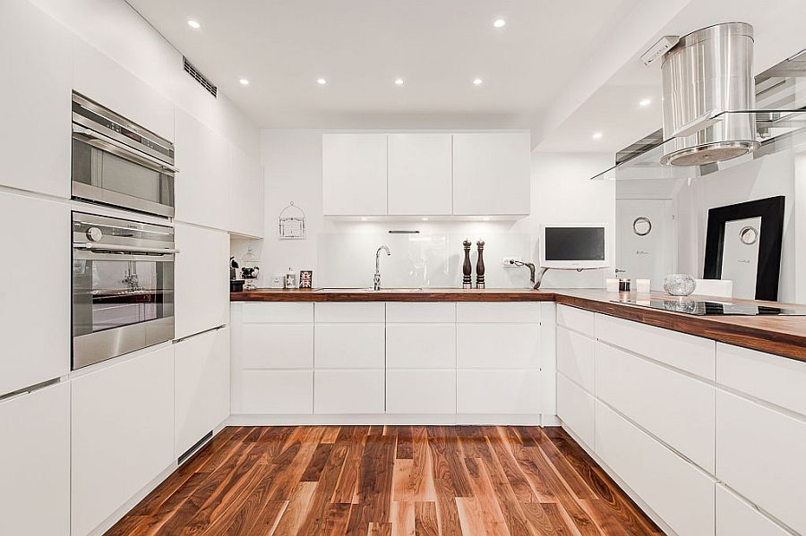 All white kitchen cabinets add to the minimal appeal of the design