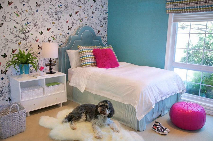 Patterned wallpaper and blind in teenager girls bedroom with white