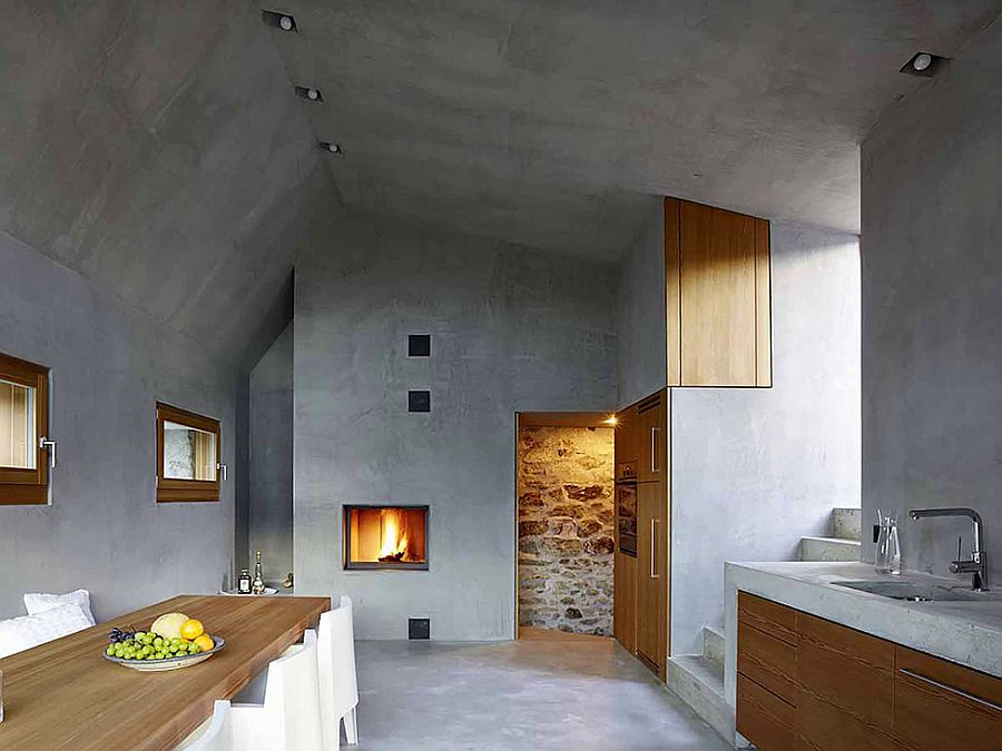 Beautiful fireplace and concrete walls shape the minimal setting