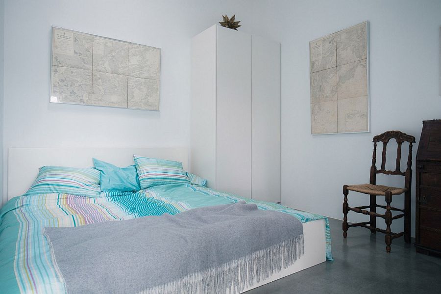 Bedding brings a touch of blue to the cool bedroom