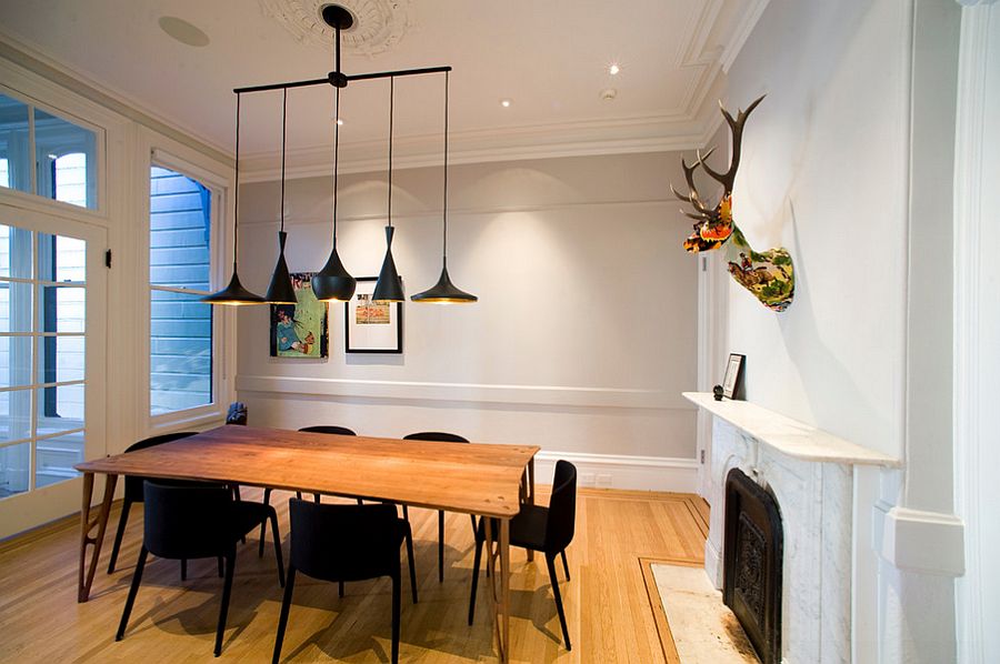 Chairs and lighting bring black to the dining room with innate simplicity