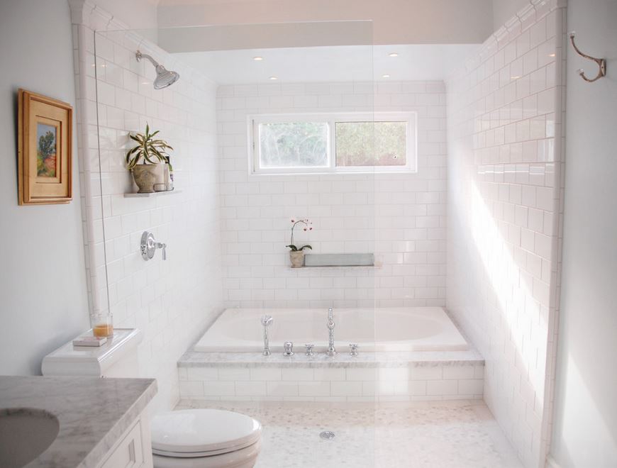 Crisp white bathroom with a sparkling tub