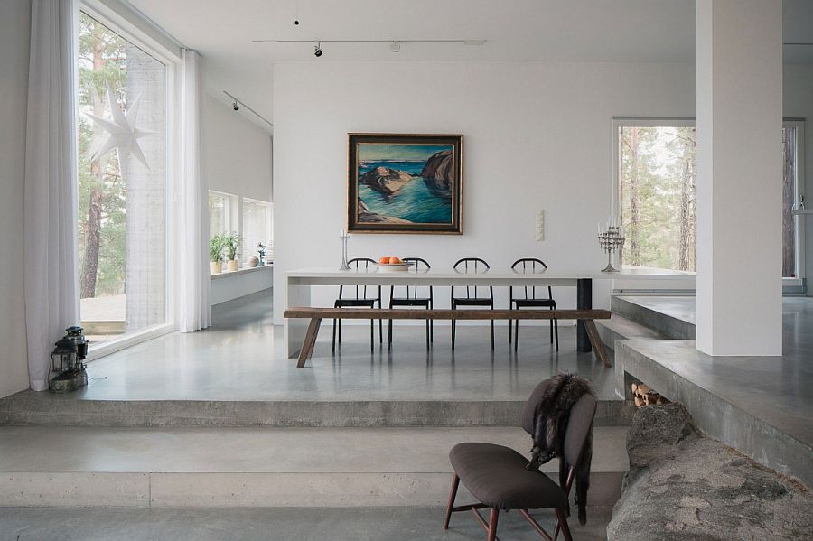 Dining area with a long wooden bench and modern chairs