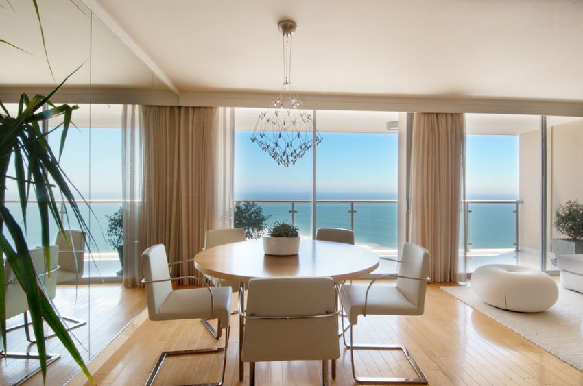 Dining room with a mirrored wall and an ocean view