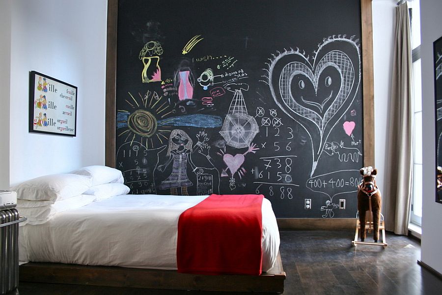 Eclectic kids' bedroom with chalkboard accent wall