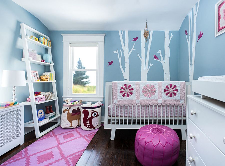 Gorgeous blue nursery with a woodsy theme and a touch of pink