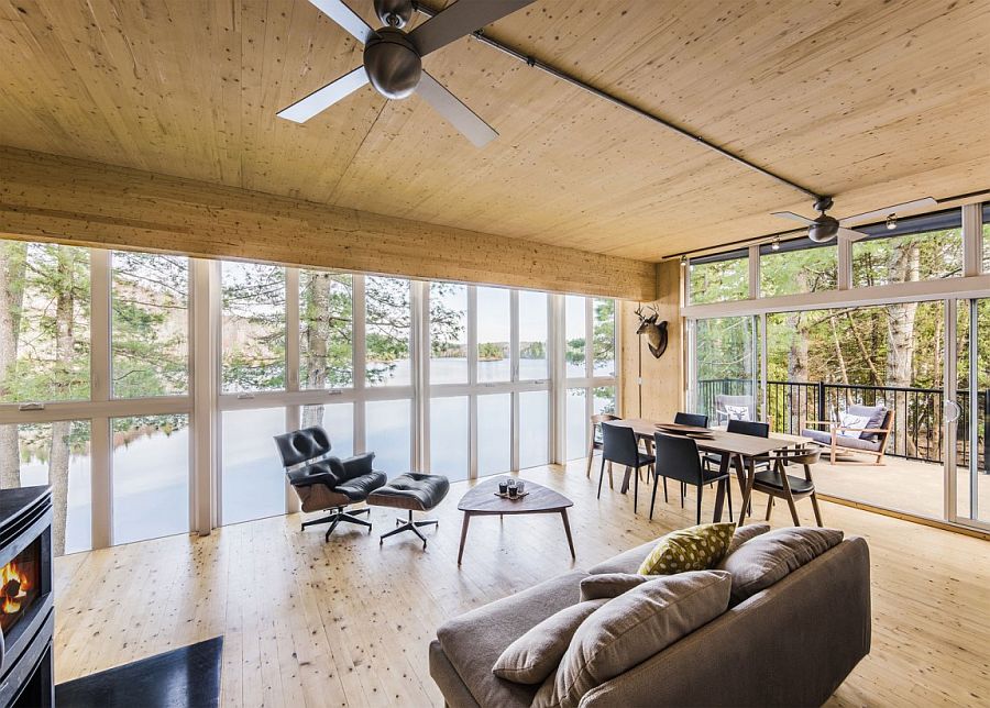 Gorgeous living area enclosed in glass panels overlooking the lake