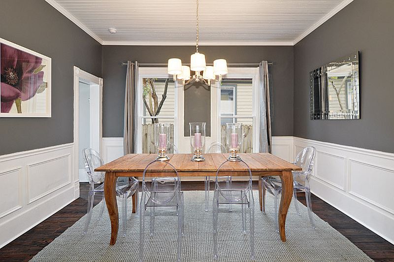 Lovely charcoal gray dining room with acrylic chairs and wooden table [Design: Avenue B Development]