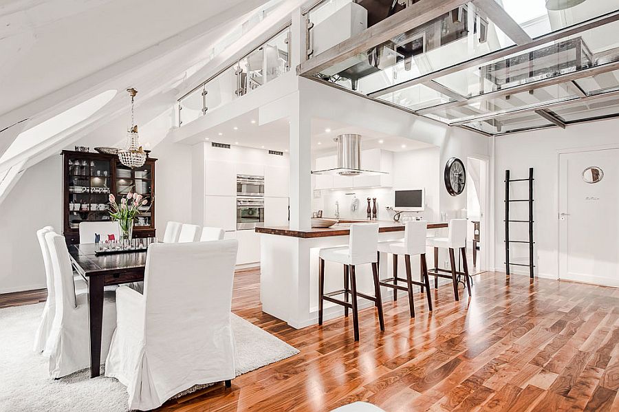 Lovely windows and the unique design of attic bring natural light into the dining area