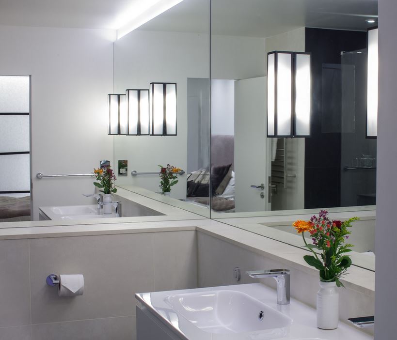 Minimalist bathroom with mirrored walls