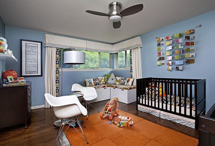 Nursery with a cozy reading nook in the corner [Deign: SAM Interiors / Jeff Garland Photography]