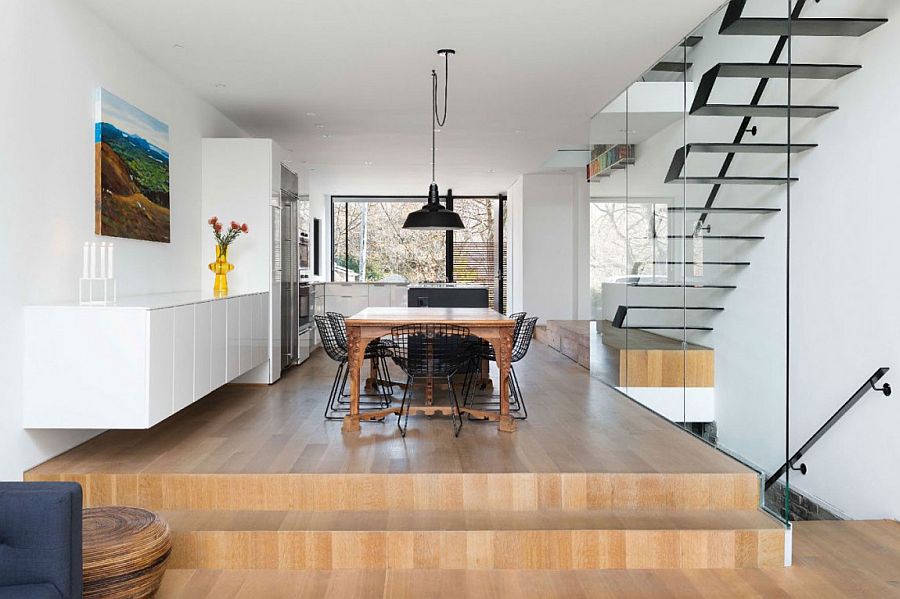 Raised wooden platform seperates the dining and kitchen areas from the entry