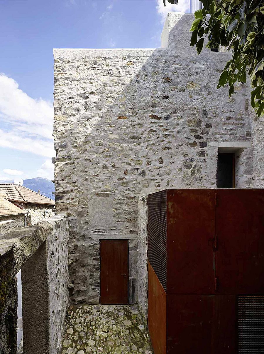 Rough metal surfaces combined with the stone walls of the house