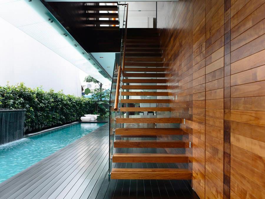 Sleek floating staircase connects the private deck with the master bedroom above