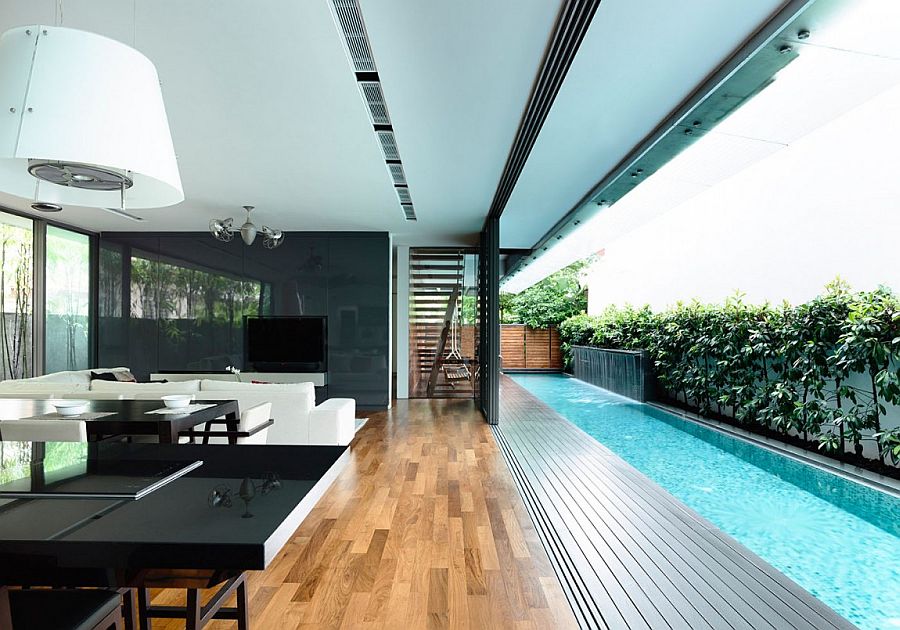 Sliding glass doors connect the interior with the courtyard and lap pool outside