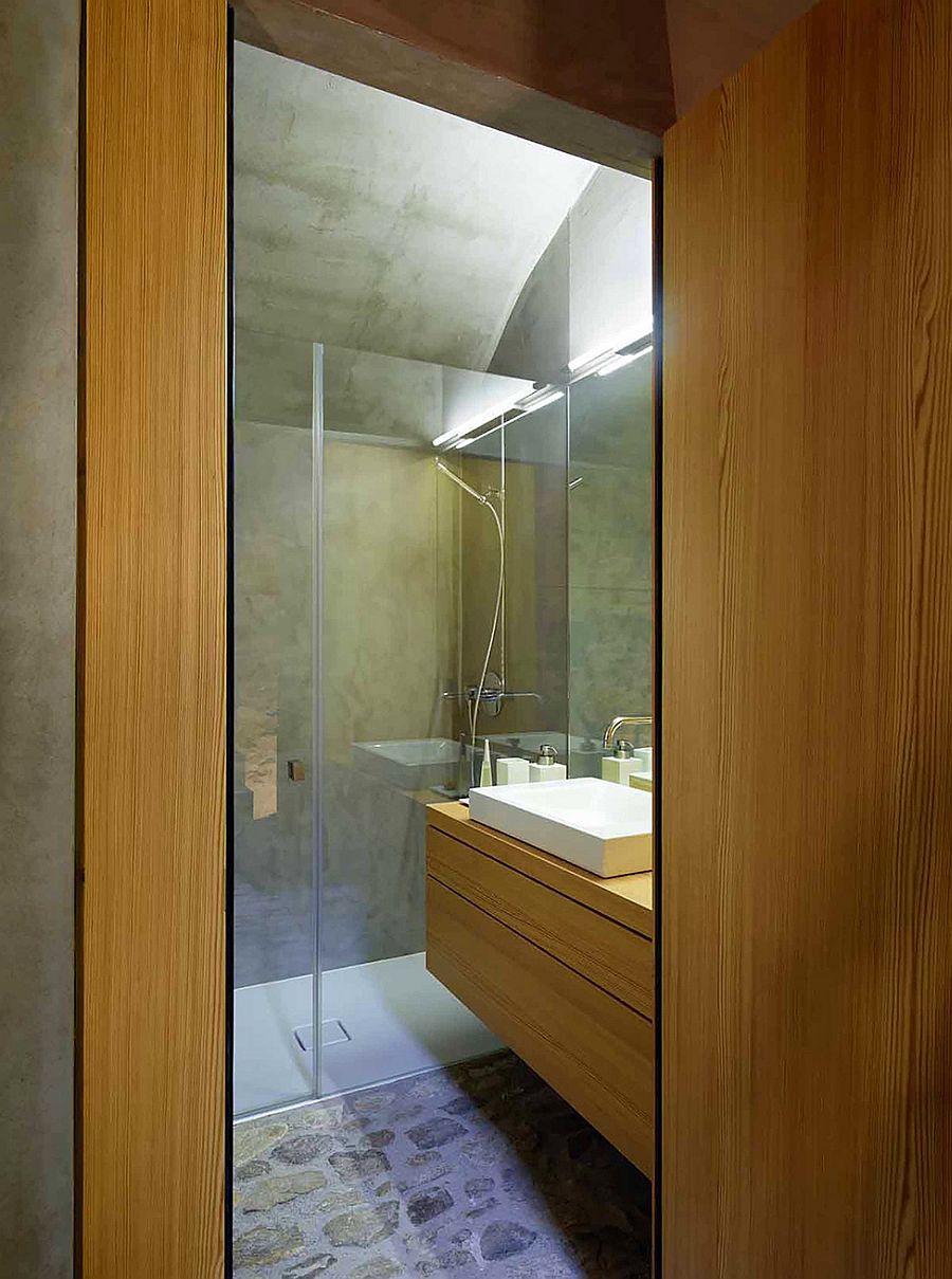 Small bathroom with wooden vanity and shower area