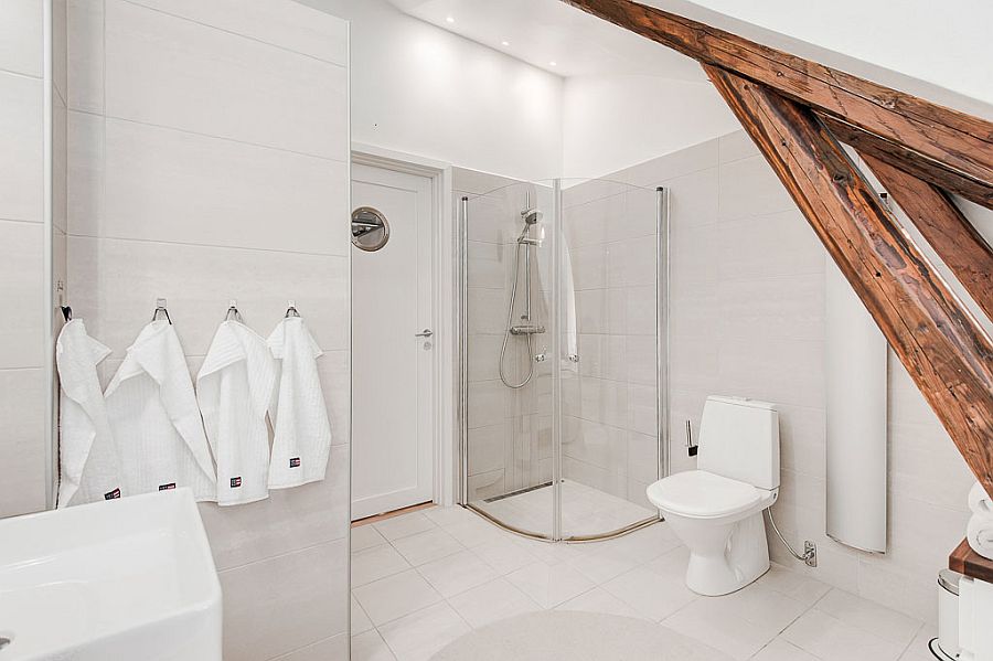 Smart white bathroom with a space-conscious design and corner shower