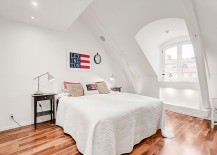 Stylish-Scandinavian-style-attic-bedroom-in-white-with-wooden-flooring-217x155