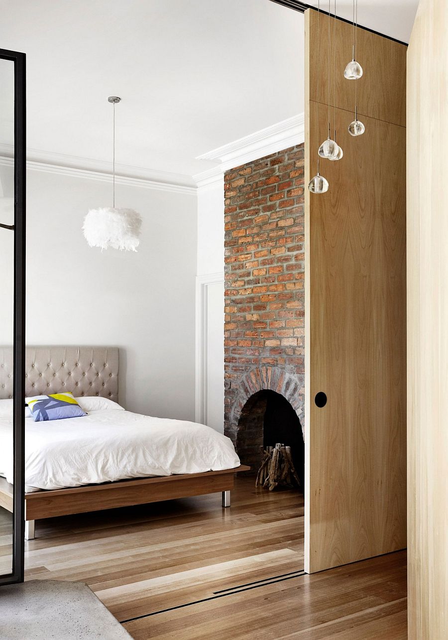 Unique brick wall in the bedroom with fireplace