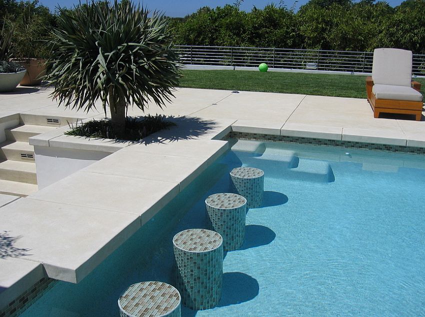 Acid etch finish concrete shapes this elegant pool deck and additional features [Design: Sage Design Studios]