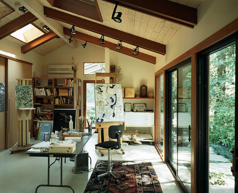 Art studio and home office connected with the outdoors through glass doors