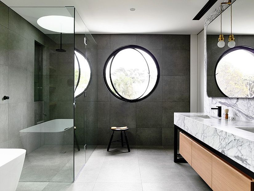 Bathroom with a minimal industrial style fetaures a marble vanity