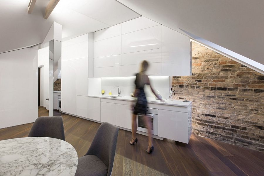 Brick wall adds an interesting visual to the modern attic apartment