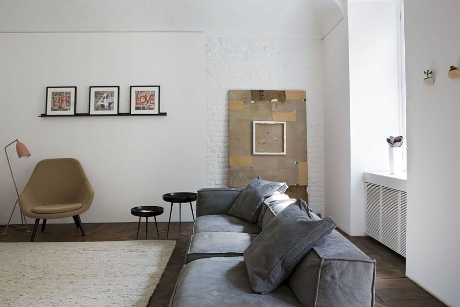 Brick wall adds textural beauty to the black and white living room