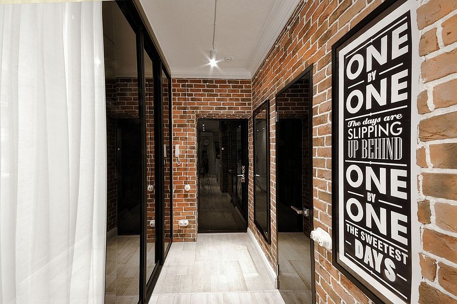 Brick walls and dark glass doors shape the entrance