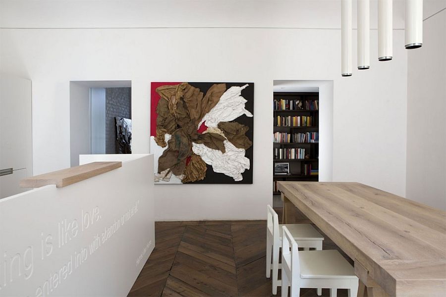 Brilliant use of pendant lights adds elegance to the minimal dining area