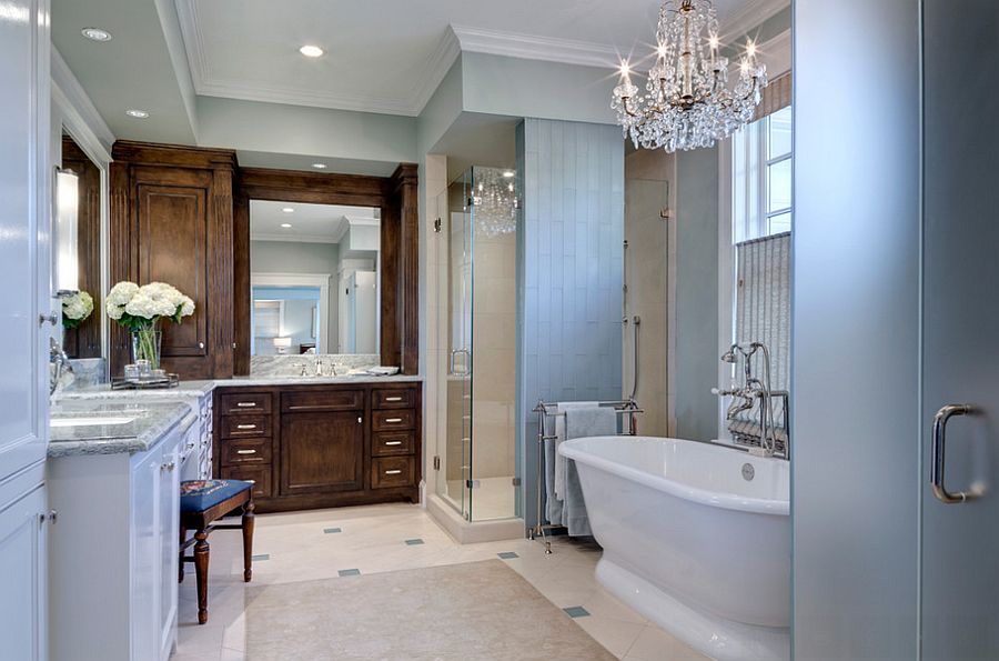 Classic glass chandelier shines in the traditional bathroom [Design: Domiteaux + Baggett Architects]