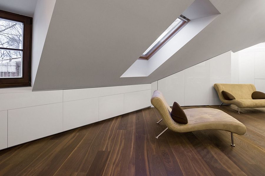 Cleverly concealed shelves in the tiny attic apartment that disappear into the walls
