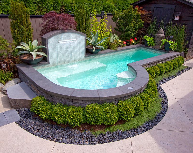 Backyard small pool with stone and water feature.