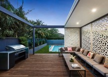 Custom-made-wall-panels-and-wooden-deck-shape-the-barbecue-area-217x155