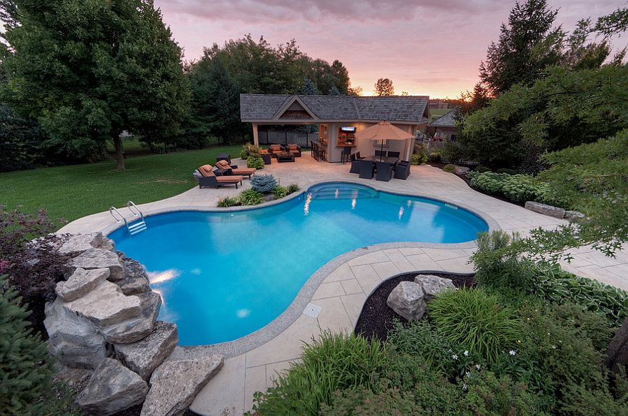 Custom stamped concrete deck complements the colors of the house [Design: Betz Pools Limited]