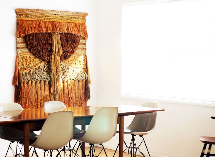 Dining room with hanging fiber art