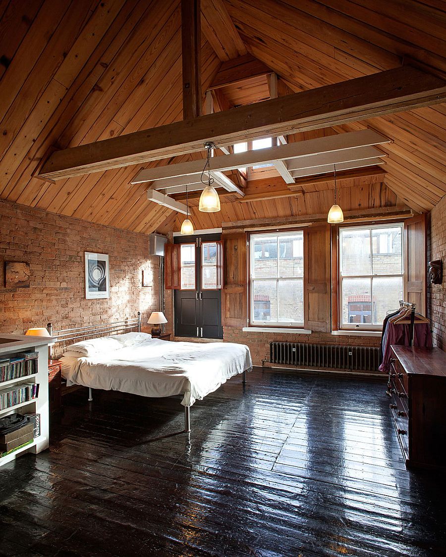 Elegant bedroom with gabled ceiling and brick walls