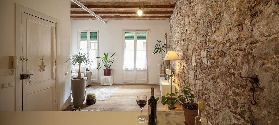 Exposed stone wall of the original structure adds uniqueness to the home