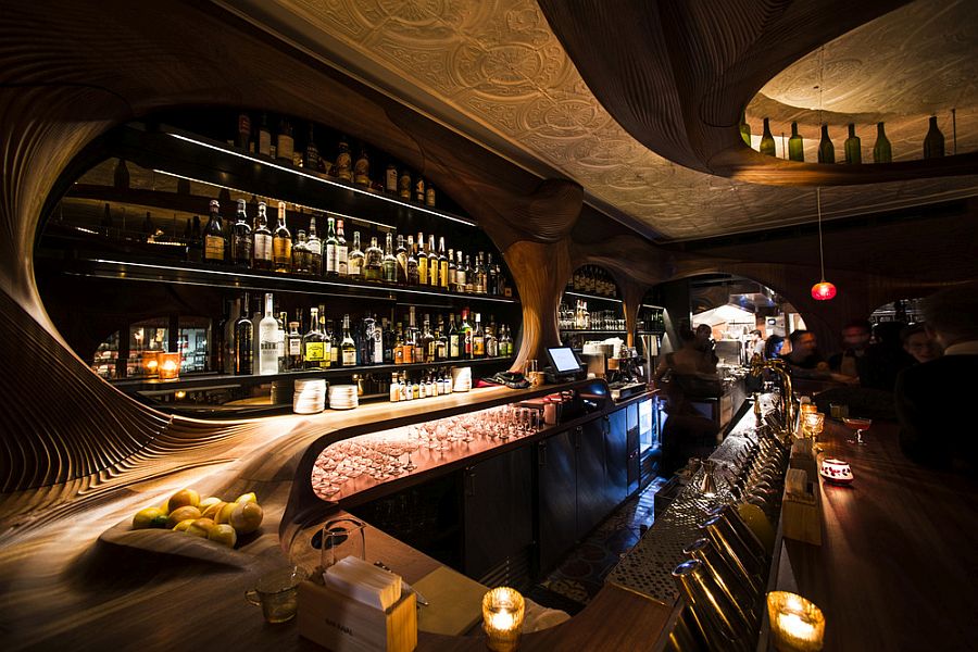 Exquisite wooden detailing and sensational lighting shape the interior of the bar