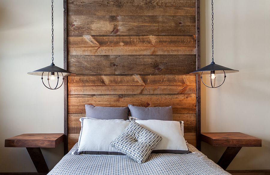 Floor-to-ceiling headboard with wooden planks in the rustic bedroom [Design: High Camp Home]