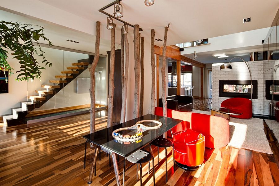 Ingenious way to create a cool partition in the open plan living area with tree trunks