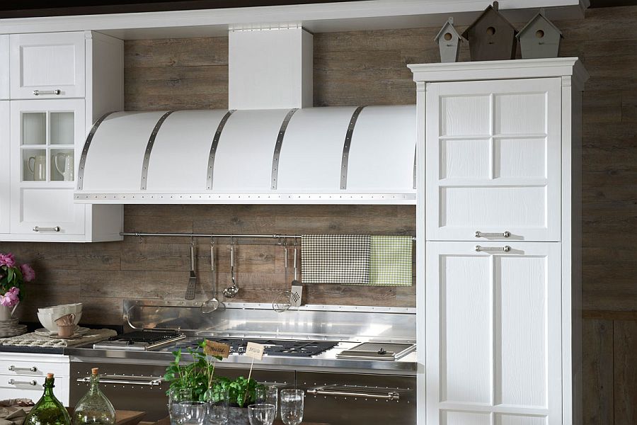 Intriguing design of the cabinets and the hood elevate the vintage appeal of the kitchen