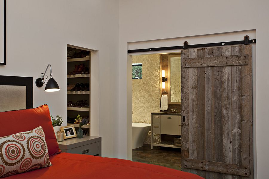 Master bedroom with barn door for the bathroom [Design: Fiorella Design]