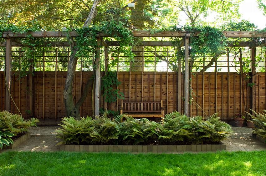 Modern pergola with seating and a gravel path