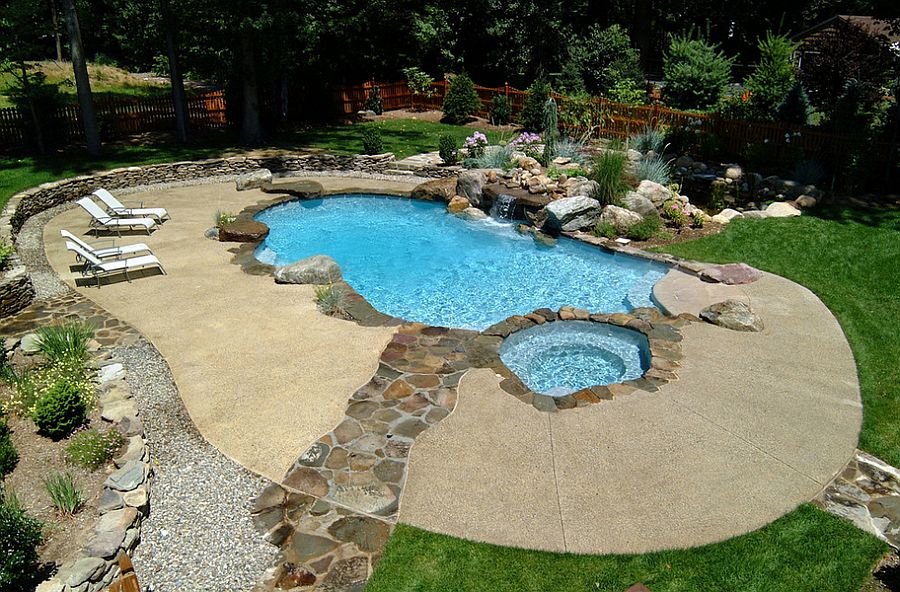 Neat concrete pool deck with a stone walkway [Design: Cool Pool]